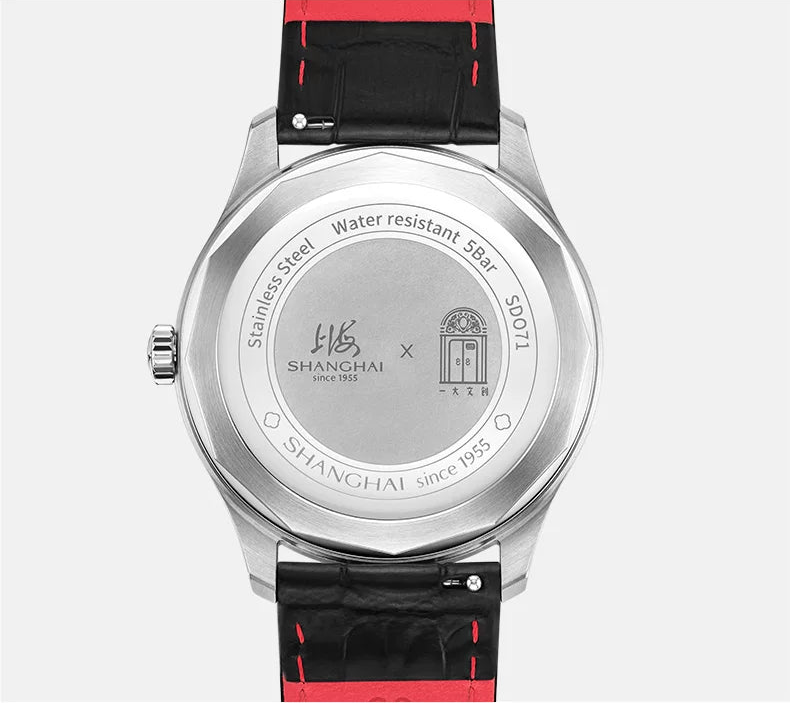Shanghai Watch brand stainless steel watch back case with a black leather strap featuring red stitching, shown against a light gray background with Chinese text above.